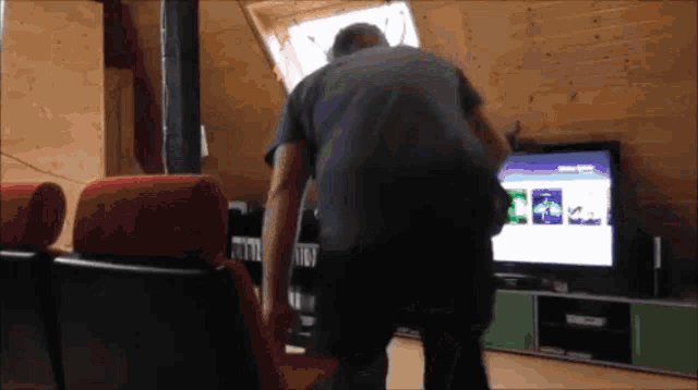 a man is standing in front of a tv that says ' netflix ' on the screen