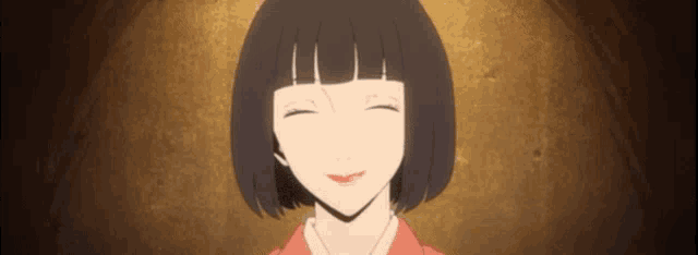 a woman with short black hair and a red shirt is smiling