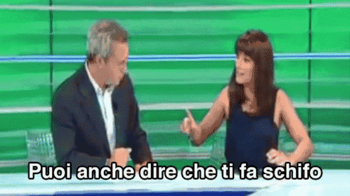 a man and a woman are sitting at a table with the words puoi anche dire che ti fa schifo on the table
