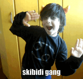 a young boy wearing a black shirt with a smiley face and the words skibidi gang on it