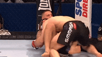 two men are wrestling in a ring with one wearing shorts that say smmash on them