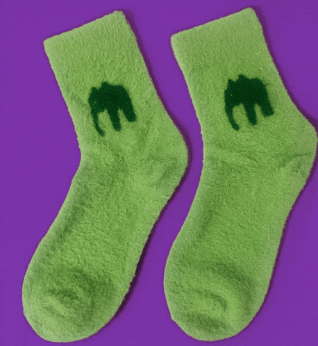 a pair of green socks with a green elephant embroidered on them