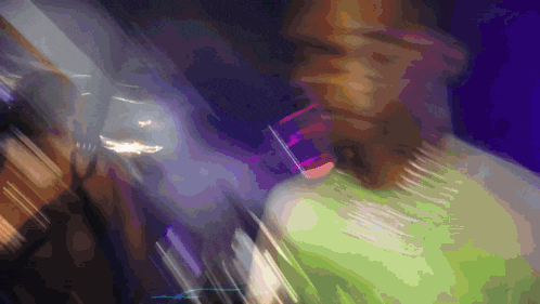 a blurry image of a person with a green shirt