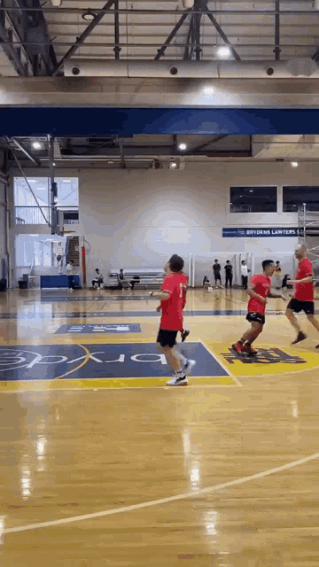 a group of people are playing basketball on a court that has a sign that says ' southern lawyers ' on it