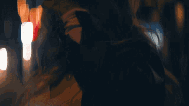 a blurry picture of a woman 's face with a red light behind her