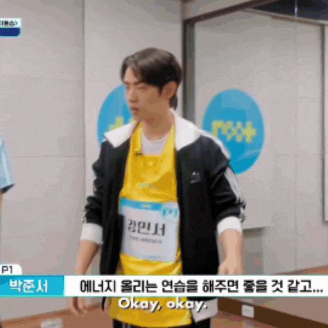 a man wearing a yellow shirt that says " okay okay "