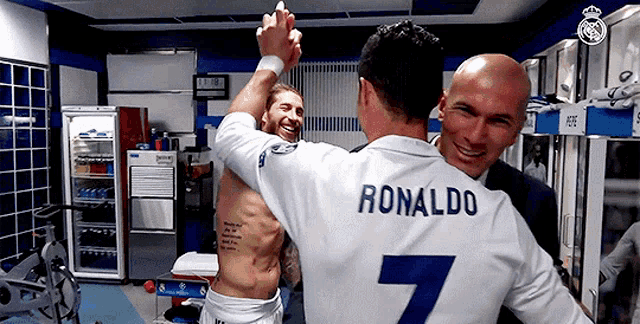 a man with the name ronaldo on his back is hugging another man