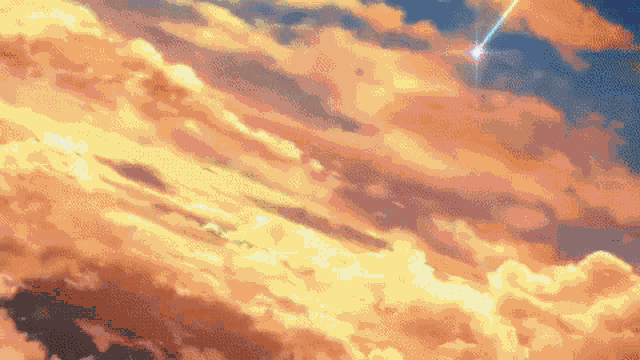 a shooting star is shining through the clouds in the sky