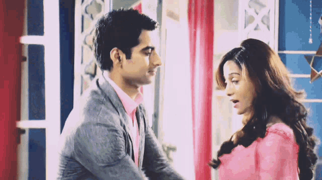 a man and a woman are looking into each others eyes
