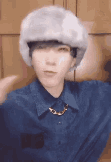 a person wearing a fur hat and a necklace