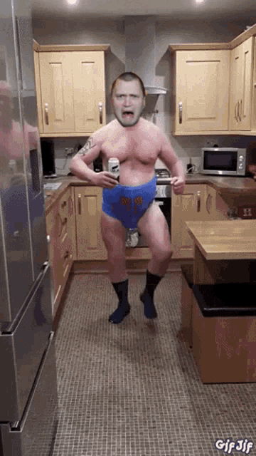 a gif of a man in a kitchen with the words gif jif on the bottom left