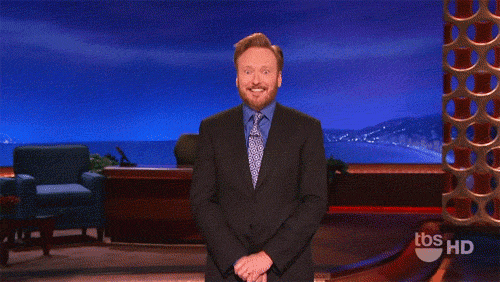 a man in a suit and tie is smiling in front of a blue background with tbs hd written on it