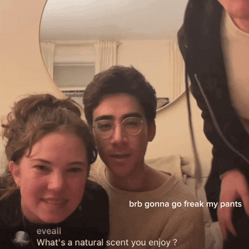 a group of people are posing for a picture and one of them says " what 's a natural scent you enjoy ? "