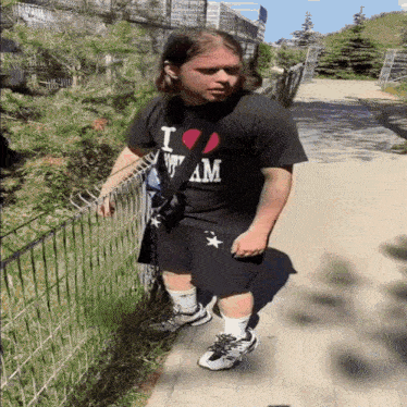 a man wearing a black shirt that says i heart my am