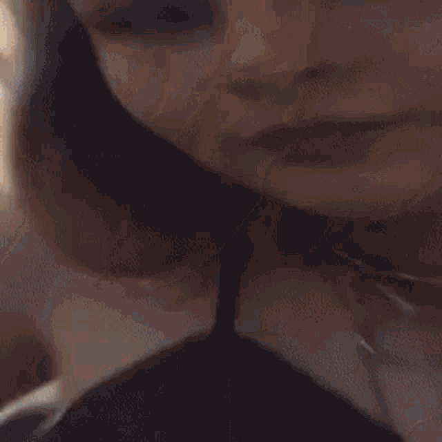 a close up of a person 's face with a blurry background