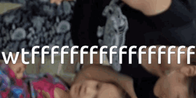 a person laying on top of a baby with the words wtf written on the bottom