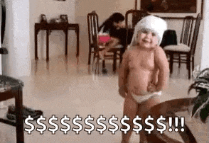 a baby in a diaper is standing in a living room with a towel on his head .