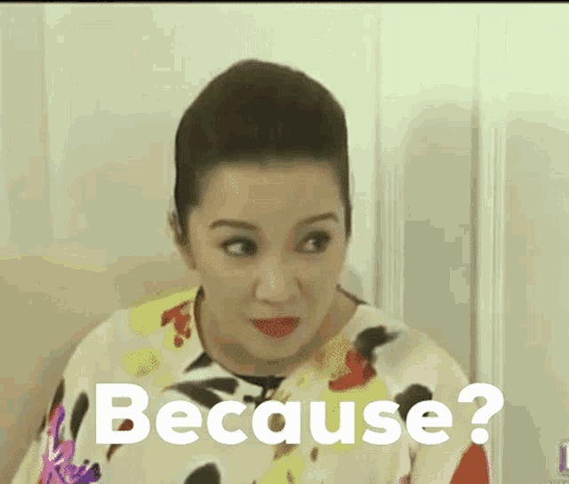 a woman is making a funny face with the words because behind her