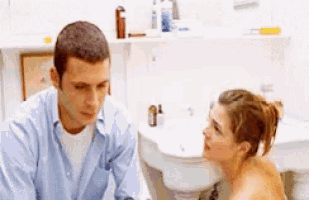 a man and a woman are sitting in a bathroom talking to each other