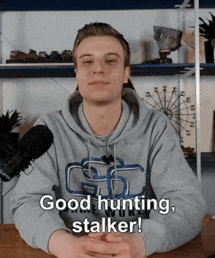 a man wearing a hoodie that says ' good hunting stalker ' on it