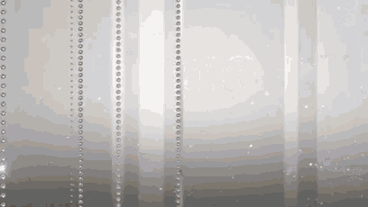 a gray background with a row of beads hanging from it