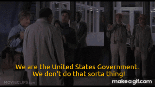a group of men are standing in a hallway and one of them is saying we are the united states government
