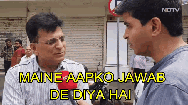 a man talking into a microphone with the caption maine aapko jawab de diya hai on the bottom