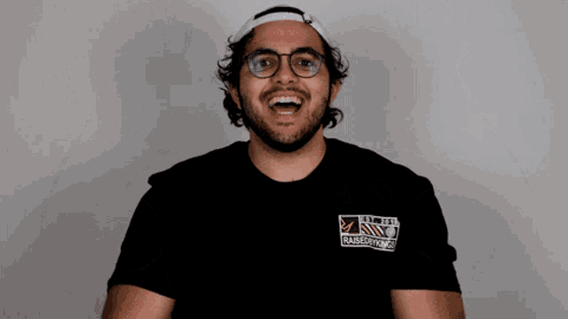 a man wearing a black shirt that says barberworks