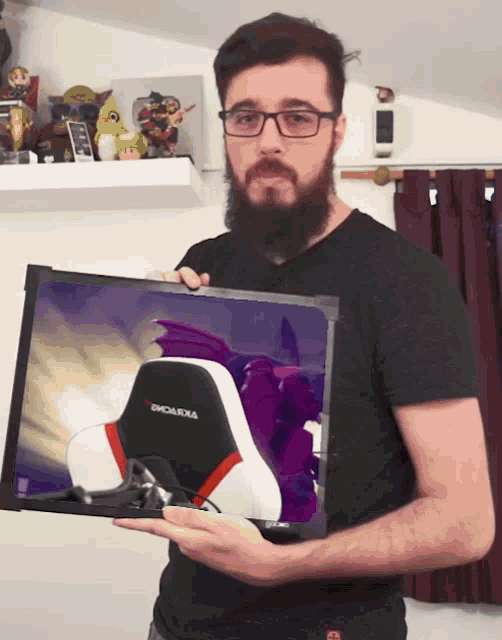 a man with a beard is holding a picture of a chair that says emoluxia on it