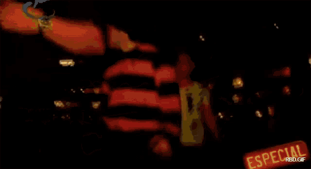 two men are dancing in a dark room with a sign that says especial