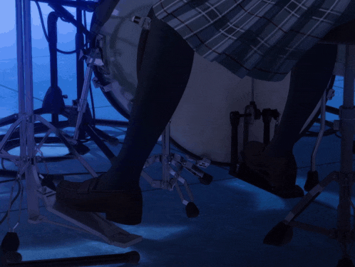 a person playing a drum set with their foot on the pedal