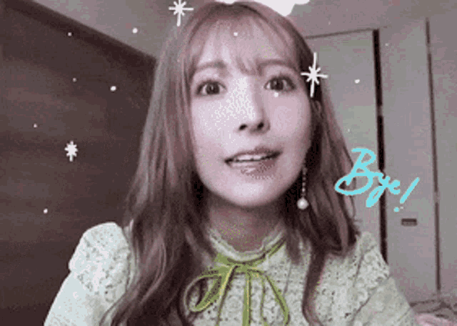 a woman in a green dress is looking at the camera with the word bye written on the bottom right corner .