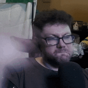 a man with glasses and a beard is wearing a black shirt