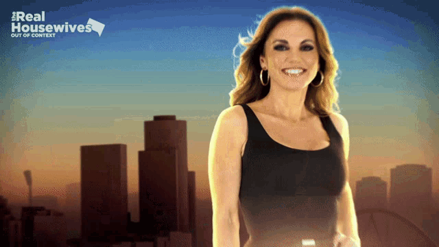 a woman is smiling in front of a real housewives poster