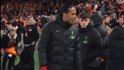 a group of soccer players are walking on a field .