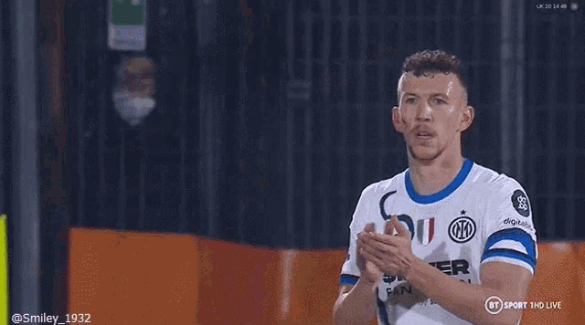 a man wearing a shirt that says $ inter fan token gives a thumbs up