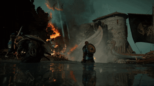 a man kneeling in the water in front of a castle on fire
