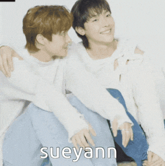 two people sitting next to each other with the name sueyann on the bottom right