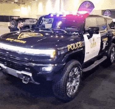 a black and white police vehicle is parked in a garage