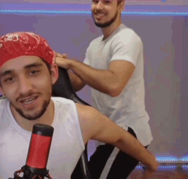 a man with a red shower cap on his head