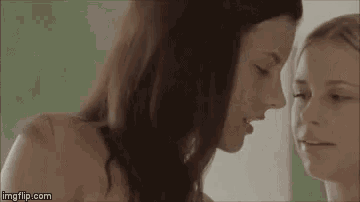 two women are touching each other 's faces .