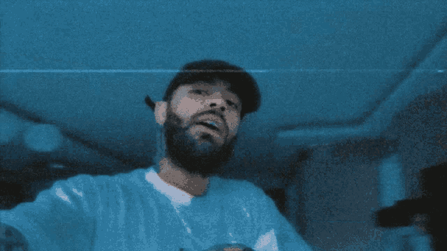 a man with a beard is taking a selfie