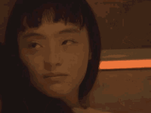 a girl is smiling with her eyes closed