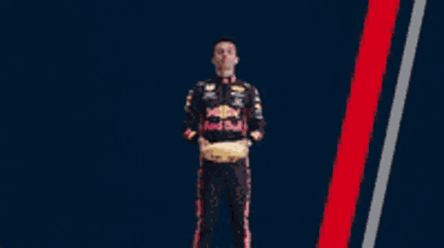 a man in a red bull outfit holds a smiley face pillow