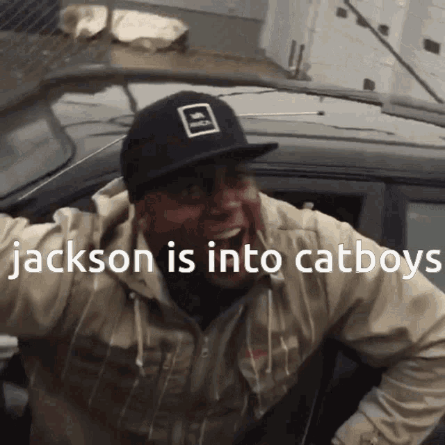 a man wearing a hat that says jackson is into cat boys