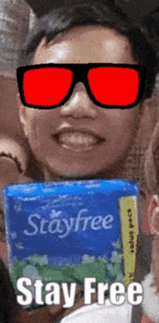 a man wearing sunglasses is holding a box of stayfree wipes