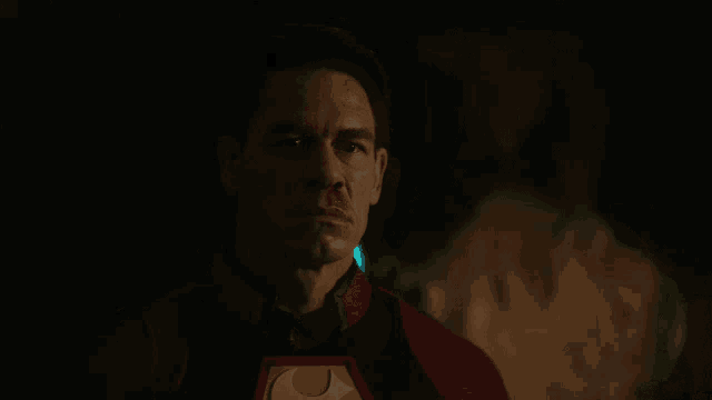 a man in a red superhero costume with the letter s on the chest