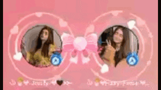 a couple of women are standing next to each other in a pink circle .
