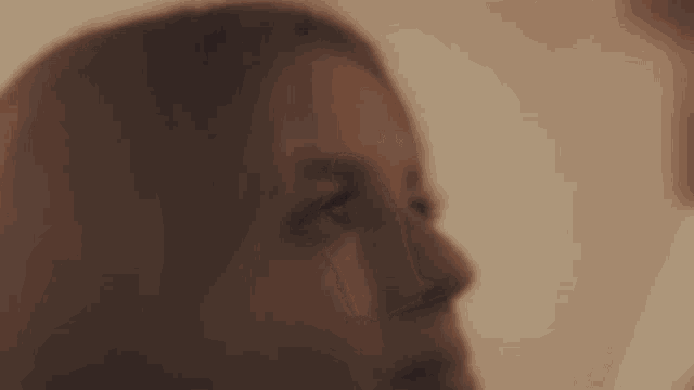 a close up of a woman 's face and a man 's face .