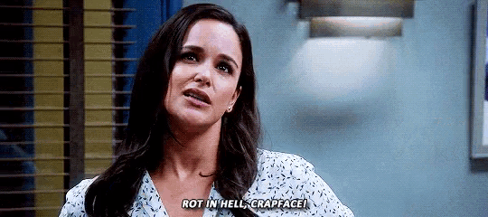 a woman is making a funny face and says `` rot in hell , crapface '' .